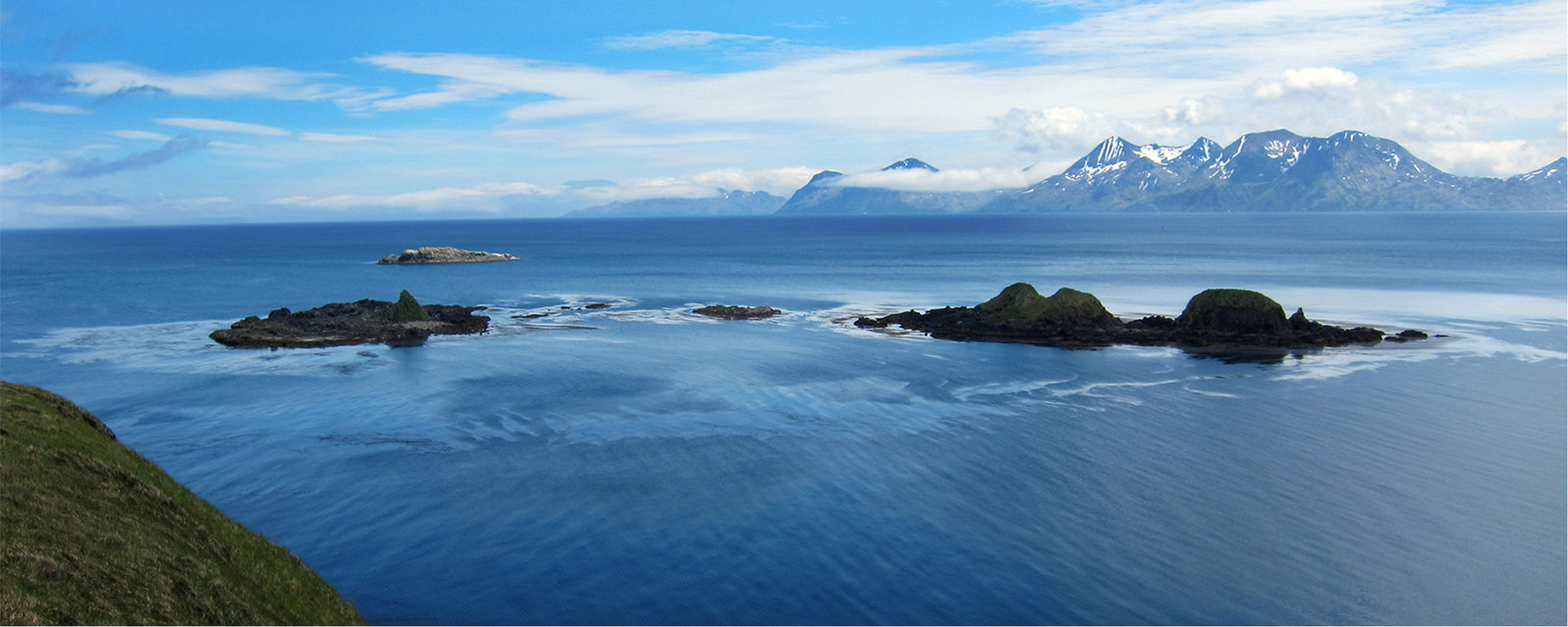 The oceans with islans in the distance. It is a beautiful sunny day.